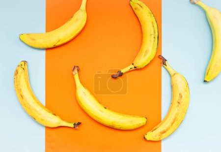 Appetizing sliced banana on a kitchen cutting board, top view. Banana without peel