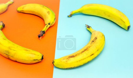 Appetizing sliced banana on a kitchen cutting board, top view. Banana without peel