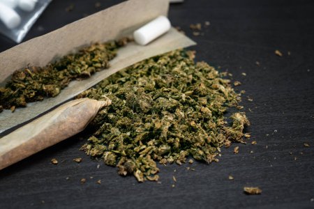 Téléchargez les photos : Close up of marijuana, Cannabis Indica on wooden background.Drugs narcotic concept. - en image libre de droit