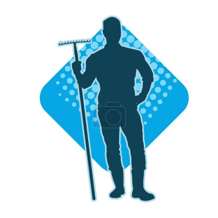 Silhouette eines männlichen Arbeiters, der eine Gartengabel oder ein Mahlgabelwerkzeug trägt