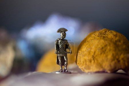 Téléchargez les photos : Roman soldier figurine posed in a cinematic tabletop scene - en image libre de droit