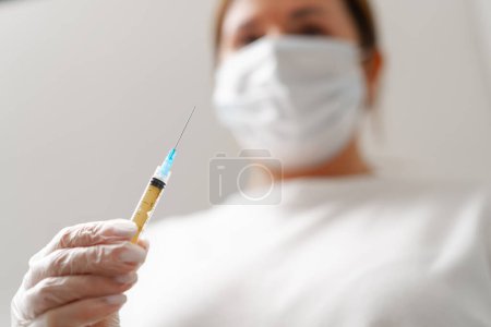 Photo for Hands of female doctor hand holding syringe for injection on background medical office The concept vaccination Cosmetology injections - Royalty Free Image