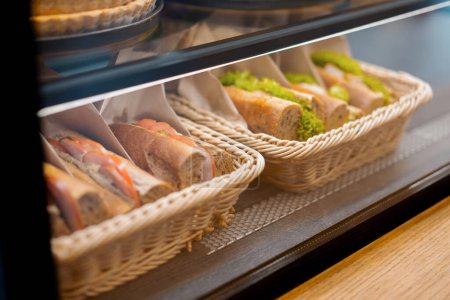 Photo for Beautiful tasty sandwiches are stacked in a basket on a store shelf, bakery - Royalty Free Image