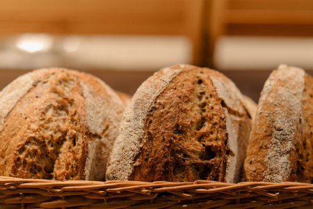 Photo for Freshly baked bread is served in baskets on the bakery counter close-up view - Royalty Free Image