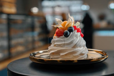 Photo for Close-up bakery delicious Pavlova dessert cake on a rotating surface - Royalty Free Image