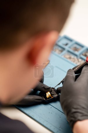 Photo for Macro shot - smart watch being repaired by an engineer - Royalty Free Image