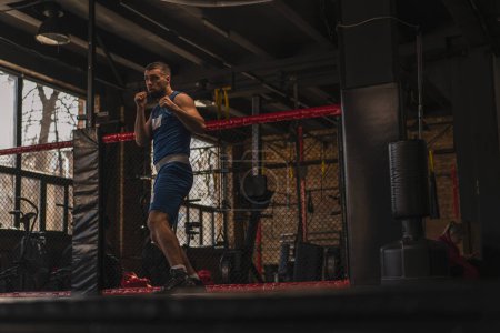 Photo for A boxer in the gym who fights with shadow practices punches - Royalty Free Image
