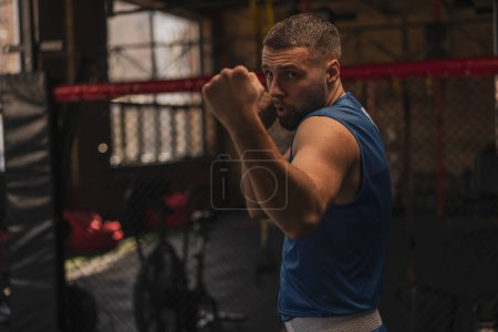 Photo for A boxer in the gym who fights with shadow practices punches - Royalty Free Image
