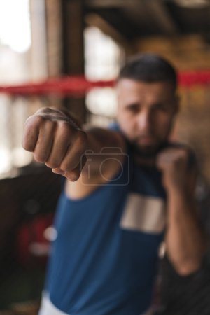 Téléchargez les photos : Gros plan d'un poing de boxeur dans un coup de poing de gymnase - en image libre de droit