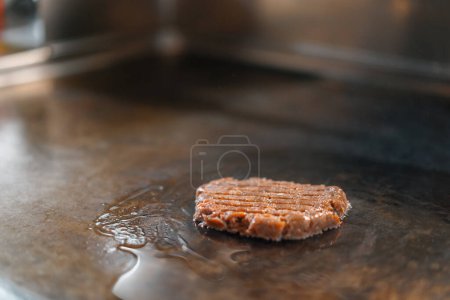Photo for Professional restaurant kitchen close-up of hamburger patties on grill smash burger beefsteak - Royalty Free Image