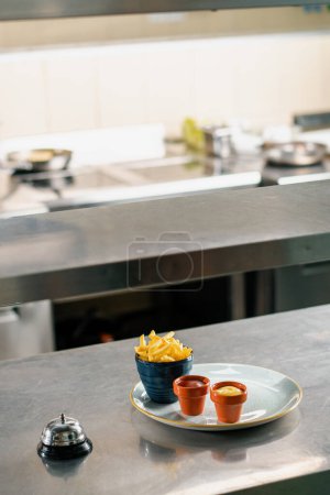 Photo for Professional kitchen in the hotel restaurant french fries and sauces on plate - Royalty Free Image