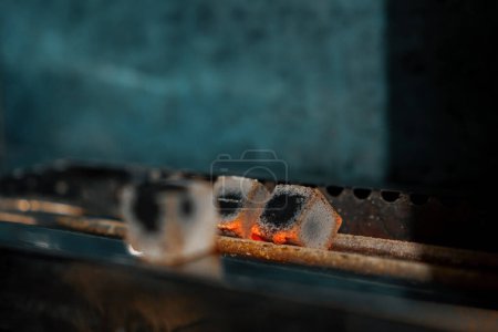 Photo for Hookah coals are roasted on the hookah cooking fire concept of work and leisure - Royalty Free Image