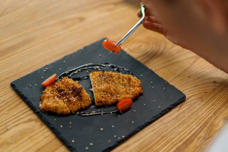 Photo for Juicy hot freshly cooked chicken fillet steak in breadcrumbs on a plate in restaurant - Royalty Free Image