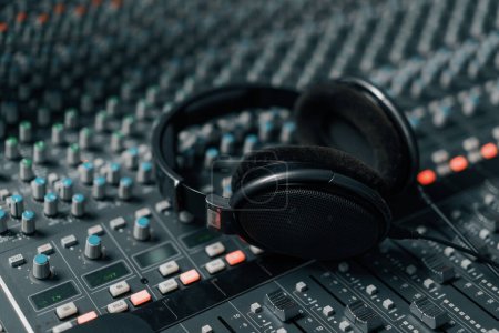 Photo for Headphones on a mixing desk in an audio recording studio podcast audio recording items for broadcasting studio - Royalty Free Image