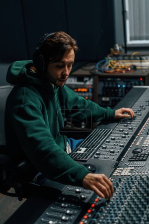 Photo for Sound engineer working in music studio with monitors and equalizer screen mixing and mastering tracks - Royalty Free Image