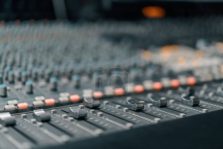 A recording studio control panel mixer with an equalizer faders buttons for broadcasting a recording of song puzzle 650248238