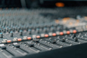A recording studio control panel mixer with an equalizer faders buttons for broadcasting a recording of song Poster #650248238