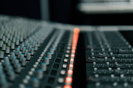 Photo for A recording studio control panel mixer with an equalizer faders buttons for broadcasting a recording of song - Royalty Free Image