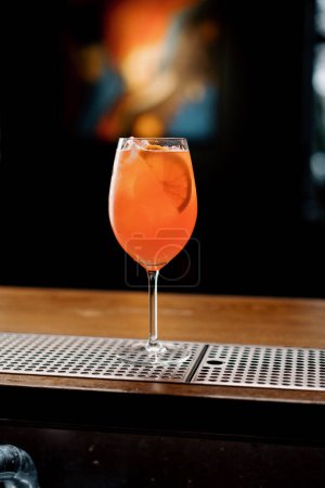 Photo for Delicious Aperol spritz cocktail standing on bar counter in restaurant bar waiting waiter and customer - Royalty Free Image
