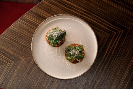 Téléchargez les photos : Délicieux naans avec pâté de champignons et capsicum saupoudré de fromage sur la table dans le restaurant - en image libre de droit