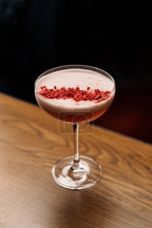 Foto de Delicioso cóctel de ponche de leche rosa recién preparado con frambuesas se encuentra en el mostrador del bar - Imagen libre de derechos