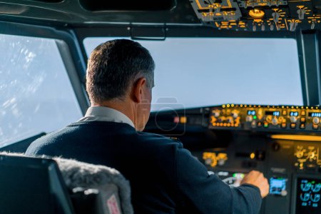 Photo for Modern passenger plane during flight in a clear sky without clouds pilot at work in the cockpit - Royalty Free Image