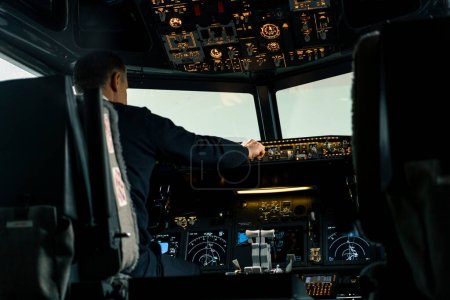 Photo for Commercial aircraft pilot adjusts aircraft flight parameters during high altitude flight View from inside cabin - Royalty Free Image