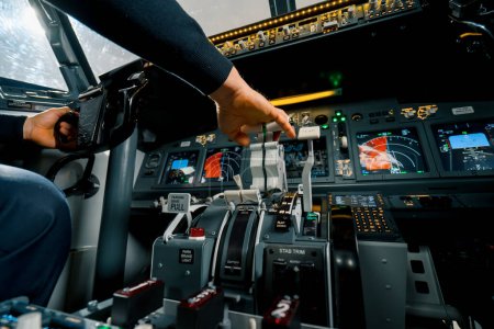 Photo for An airplane pilot controls the throttle during flight takeoff View from inside the cabin - Royalty Free Image
