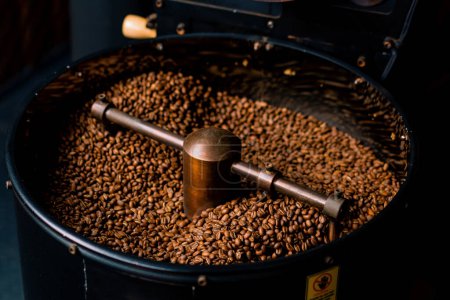 Photo for Coffee production is the process of roasting fresh coffee beans coffee beans mixed and cooled close-up - Royalty Free Image