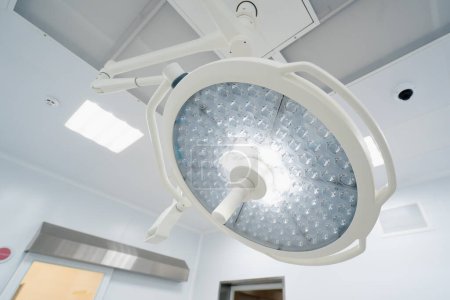 Photo for Big round modern lamps on the surgery room ceiling Advanced illumination equipment surgeries in present day clinics - Royalty Free Image