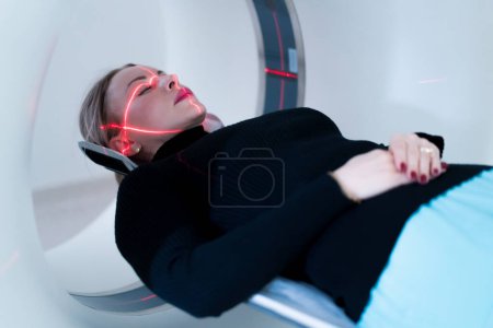 Photo for The patient undergoes computer tomography in hospital scanner high-tech equipment and diagnostics - Royalty Free Image