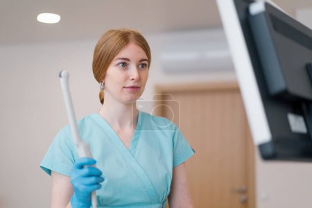 Photo for A gynecologist holds a transvaginal ultrasound device in his hands for diagnosing patient in the clinic - Royalty Free Image