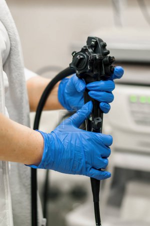 Photo for Close-up  doctor's gloved hand with endoscope during diagnostic gastroscopy or colonoscopy in clinic - Royalty Free Image