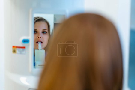 Photo for Scanning of the dental jaw The patient undergoes a procedure of panoramic radiography of oral cavity in modern dentistry - Royalty Free Image