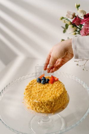Téléchargez les photos : Délicieux gâteau Napoléon fraîchement préparé de pâte feuilletée à la main décore le dessert avec des fraises et des baies fraîches - en image libre de droit