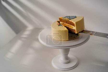 Photo for Delicious freshly prepared biscuit bento cake decorated with a picture of a cat a piece of dessert on knife - Royalty Free Image