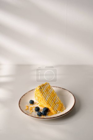 Photo for Delicious piece of freshly made honey cake drizzled with honey on a plate with berries on white background desserts concept - Royalty Free Image