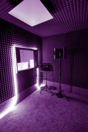 Photo for Empty recording studio with professional equipment microphone stand sound engineer window purple neon light - Royalty Free Image