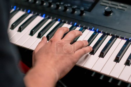 Photo for Professional recording studio sound engineer music producer musician pressing synthesizer keys - Royalty Free Image