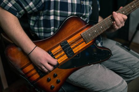 Téléchargez les photos : Interprète rock avec guitare électrique en studio d'enregistrement jouer sa propre piste instruments de musique cordes mélodie - en image libre de droit