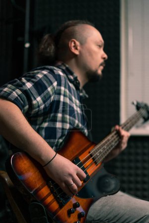Photo for Rock performer with electric guitar in recording studio recording playing own track musical instrument strings melody - Royalty Free Image