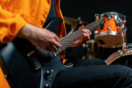 Téléchargez les photos : Interprète rock avec guitare électrique dans l'enregistrement studio jouer sa propre piste création chanson instrument de musique cordes gros plan - en image libre de droit