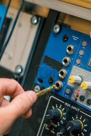 Foto de Ingeniero de sonido conecta cable de audio alambres profesionales con conectores estudio de grabación de equipos de música - Imagen libre de derechos