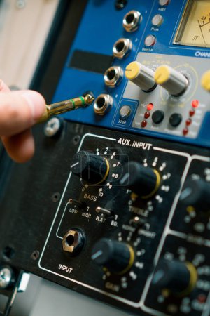 Photo for Sound engineer connects Audio cable Professional wires with connectors music equipment recording studio - Royalty Free Image