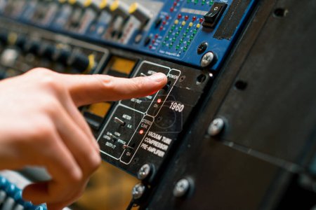 Photo for Sound Engineer Using Digital Audio Mixer Sliders Engineer Pressing Power Button Control Panel Recording Studio Technician Closeup - Royalty Free Image