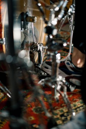 Photo for Man's foot pressing bass drum pedal in recording studio drummer drumming indoors closeup - Royalty Free Image