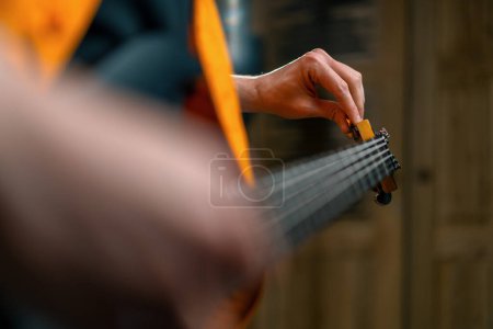 Photo for Rock performer with electric guitar in recording studio recording playing own track tuning musical instrument strings closeup - Royalty Free Image