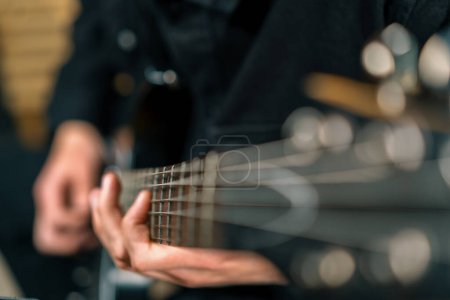 Photo for Rock performer with electric guitar in recording studio recording playing own track creating song musical instrument strings closeup - Royalty Free Image