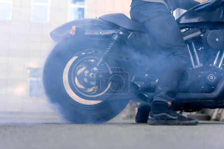 Photo for Close up of a motorcycle wheel burning rubber Smoke and sparks from under the wheels of a sport motorbike racing Need for speed - Royalty Free Image