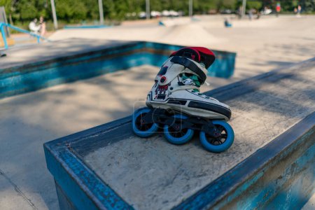 Photo for Roller skates lie on the sports court in the skate park before the start of street sports equipment - Royalty Free Image